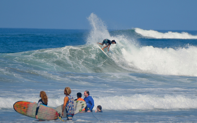 Surfer catching a wave at Playa Guiones in Nosara