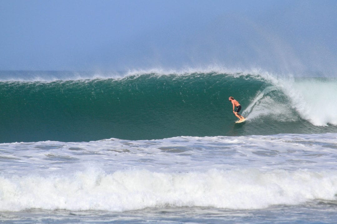Advanced surfer on a fast hollow wave at Playa Nosara