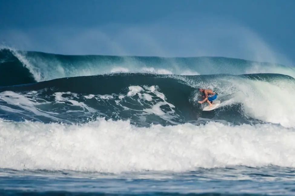 Advanced surfer riding a heavy hollow wave barrel in Mal País near Santa Teresa